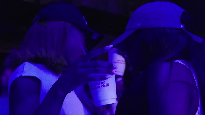 two friends sharing a moment in the crowd
